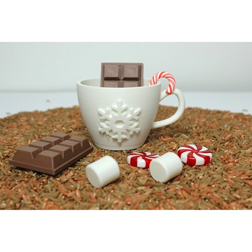 Kopje met sneeuwvlok in winterse sensorische speelbak met chocola en marshmallows bij het speellab